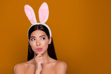 Photo of lovely asian lady smooth glowing facial skin bunny ears head hold arm chin make ponder...