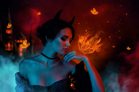Picture collage of lady satan look mystically hand fire drawing butterfly isolated on dark mist color hell backgroundの写真素材