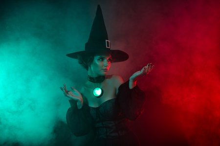 Photo of frightening fear sorceress wandering dark forest doing necromancy isolated on wicked fog colors backgroundの写真素材