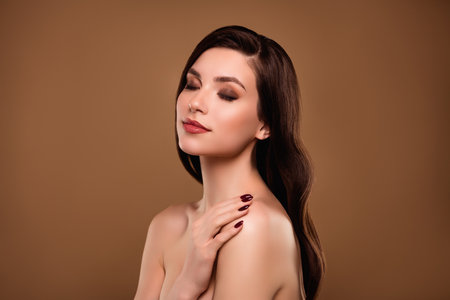 Photo of fancy pretty stunning lady touch shoulders feel happy soft skin after spa procedure pastel color backgroundの写真素材