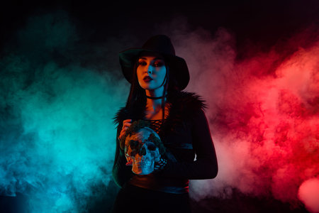 Photo of dangerous powerful lady hold dead skull bones for necromancy ritual over mist misty...