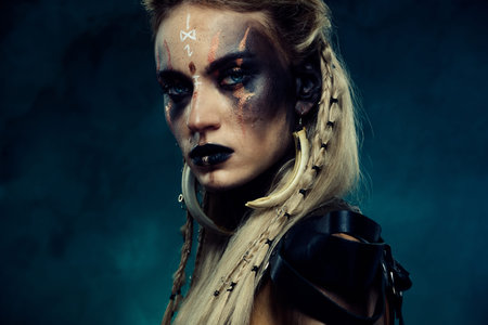 Close up photo of powerful viking queen princess with scar experienced fighter in north war over...