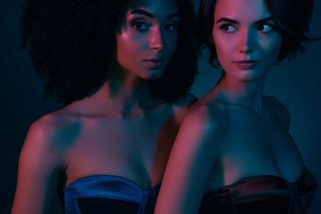 Photo of stunning ladies attract rich handsome guy millionaire on futuristic discotheque with neon backgroundの写真素材