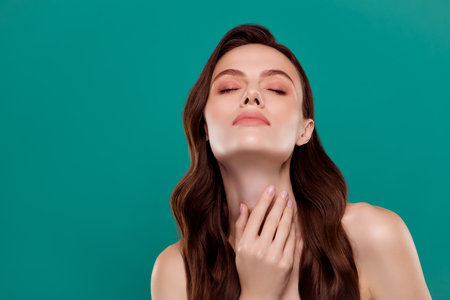 Photo of adorable seductive woman nude shoulders hand neck closed eyes empty space isolated green color backgroundの写真素材