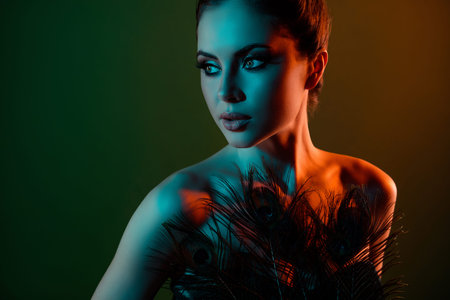 Photo of passionate gorgeous lady with peacock feather advertise beauty care prepare for vogue events occasionの写真素材