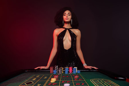 All in poker photo of chic hot tempting lady dealer invite players in poker club bet for winning holdem wager jackpotの写真素材