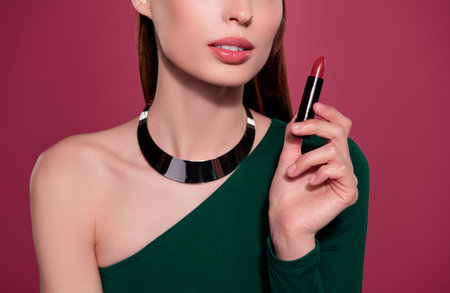 Cropped photo of chic glamorous lady hold lipstick for pouted plump lips prepare for date with boyfriendの写真素材