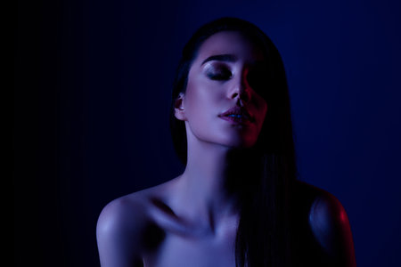 Photo of gorgeous lady feel tempting with closed eyes isolated neon color backgroundの写真素材