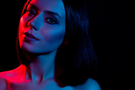 Close up photo of pretty girl look camera under neon lights isolated dark color backgroundの写真素材