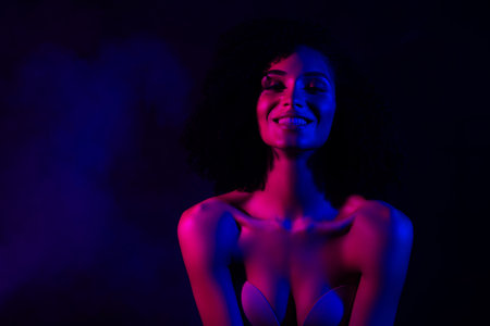 Photo of shiny tempting lady nude shoulders enjoying herself empty space isolated neon violet color backgroundの写真素材