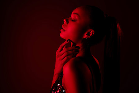 Profile side photo of attractive african girl touch face feel flirty passion isolated red neon color...