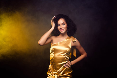 Photo of classy dreamy lady wear gold dress enjoy dance festive isolated black color background