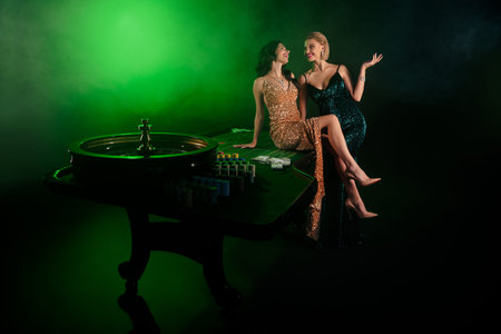 Photo of chic vip ladies professional poker players shark talking bluff cheating before playing poker gameの写真素材