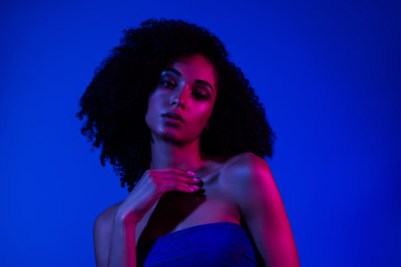 Photo of pretty girl lady feel tempting touch fingers chest isolated blue neon color backgroundの写真素材