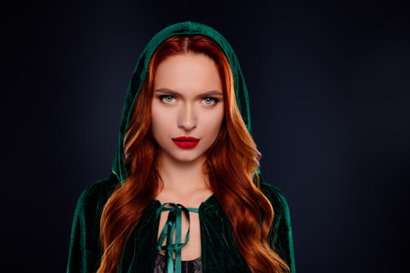 Photo of dark witch lady wear green cloak coat look dangerous isolated on black color backgroundの写真素材