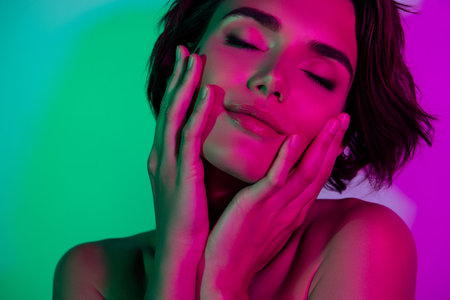Photo of pretty girl close eyes touch face hands enjoy skin face isolated multicolor backgroundの写真素材