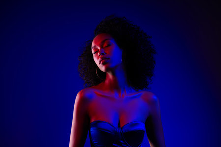 Gorgeous elegant attractive girl enjoying event club party isolated on blue neon color backgroundの写真素材