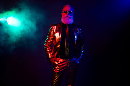 Confident serious boss wear stylish outfit celebrate corporate new year party isolated on dark neon...
