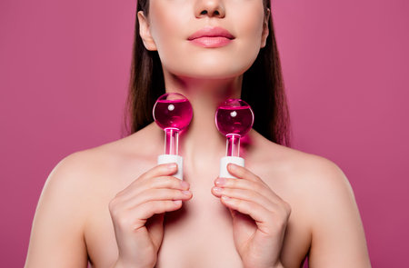 Cropped photo of girl touch body with oil flask for soft skin isolated pink color background
