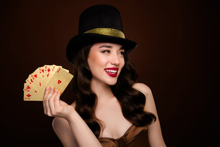 Photo of rich wealthy happy attractive lady poker risky theme empty space isolated on brown color backgroundの写真素材