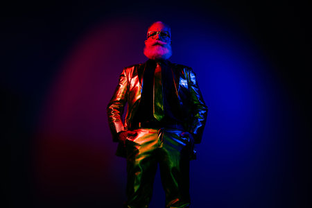 Photo of brutal macho man wear stylish outfit festive event occasion isolated on dark neon color backgroundの写真素材