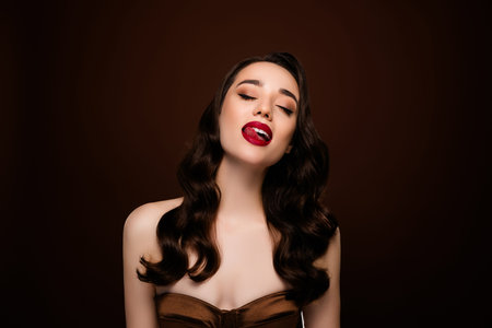 Photo of lovely gorgeous attractive lady enjoying taste isolated on brown color backgroundの写真素材