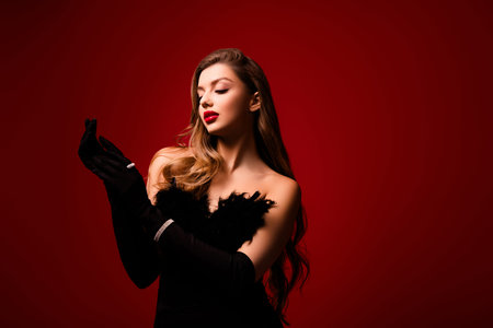 Photo of gorgeous lady wearing black gloves preparing for glamour event occasion on red color backgroundの写真素材