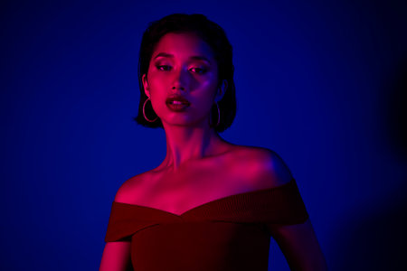 Photo of lady wear off shoulders dress celebrating nightclub isolated blue color backgroundの写真素材