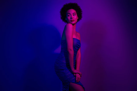 Photo of model posing dress club isolated on neon purple color backgroundの写真素材