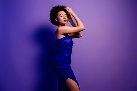 Photo of gorgeous lady hand head posing festive event luxury garment over purple gradient color backgroundの写真素材