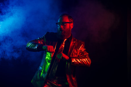 Charismatic gentleman in glowing suit embracing neon night with retro vibes and charmの写真素材