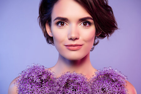 Photo of pretty gorgeous lady with shoulders exposed enjoying wildflowers blossom isolated on violet color backgroundの写真素材
