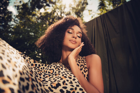 Mesmerizing fashion model in an outdoor photoshoot, embracing light and nature, showcasing elegance, diversityの写真素材