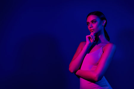 Young Woman in Neon Lights, Blue and Pink Club Atmosphere, Stylish Fashion and Beauty Conceptの写真素材