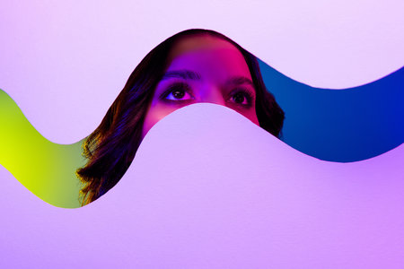 Close-up of an attractive woman with neon lighting and abstract wave patterns creating an artistic and stylish effectの写真素材