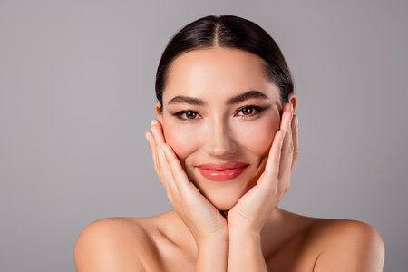 Portrait of a charming young woman with radiant makeup, flawless skin, and a joyful expressionの写真素材