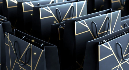 Black paper shopping bags on black background. 3d render illustration.の素材