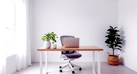 working space with computer on table and plant in pot on white wall backgroundの素材