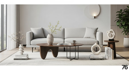a bright living room features a gray sofa, a wooden coffee table, and decorative items on a light rug.の素材