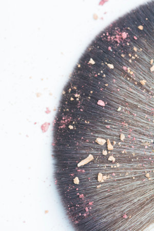 top view of close up lens blur makeup brush whit blusher crak