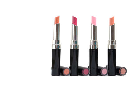 isolated four colorful of shiny lip sticks,there are orange, rosy pink, bright pink and natural brownの写真素材