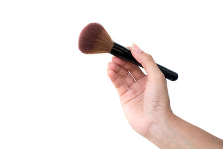 isolated professional makeup brush in women's handの写真素材