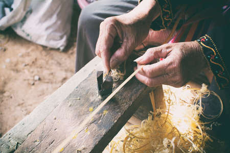 handicrafts thin bamboo stripes making with old man handsの写真素材
