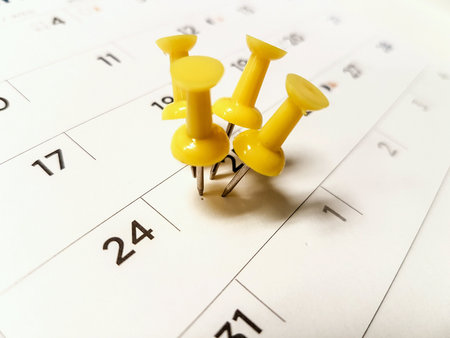 Calendar marked date with yellow pushpin / tripped pin.
