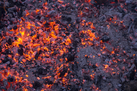 Wooden embers beautifully glowing, background warm light
