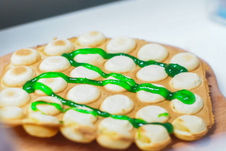 Hong Kong waffle, with syrup, the girl holds in her hands.の写真素材