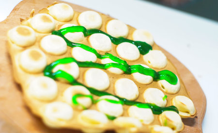 Hong Kong waffle, with syrup, the girl holds in her hands.の写真素材