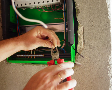 Electrician installing light in a new house