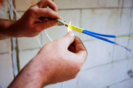 Electrician installing light in a new houseの写真素材
