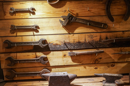 A collection of vintage tools displayed on a background of grey barnboard.